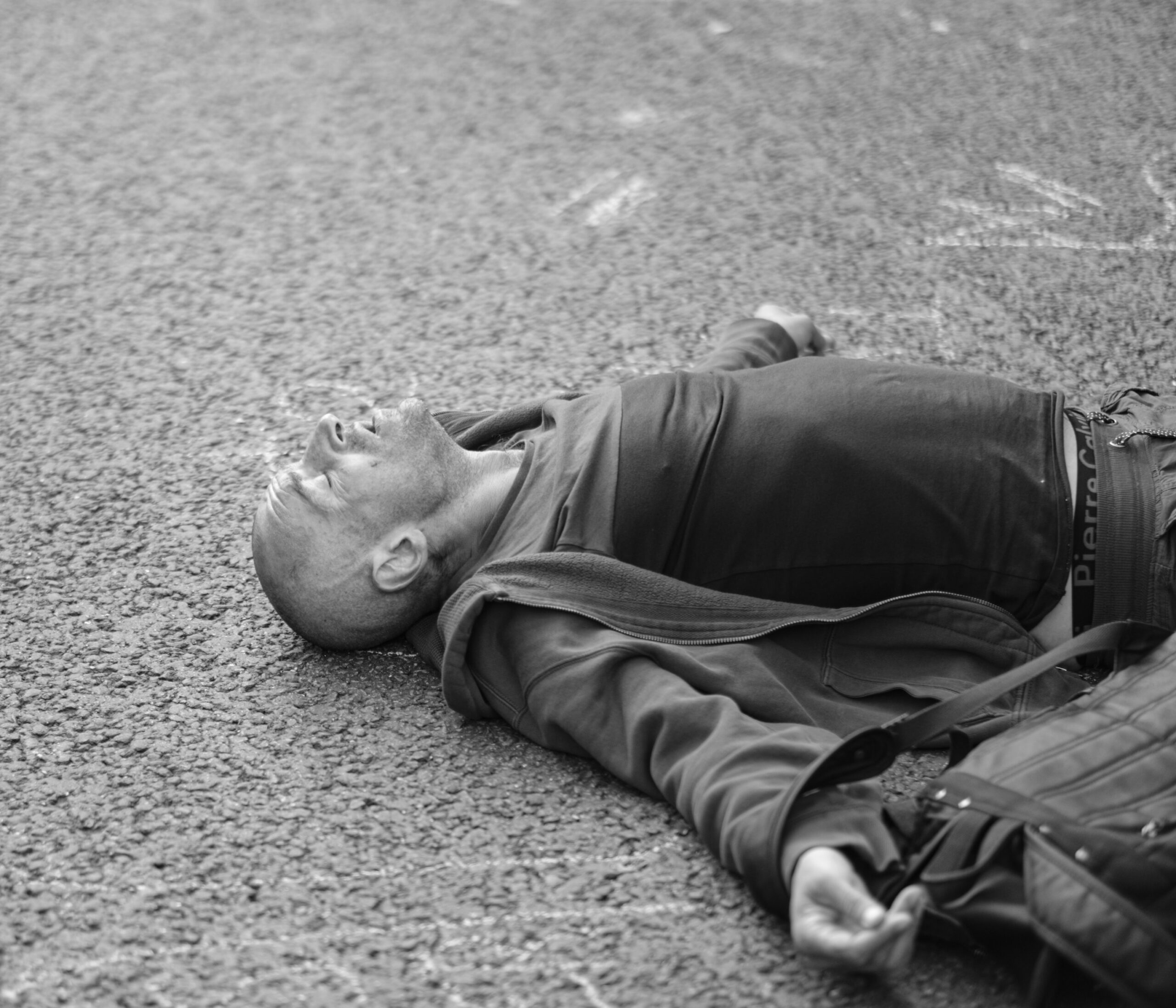 man lying exhausted on pavement Quit parenting strategically